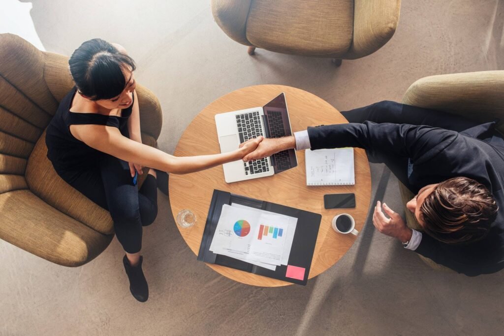 Business Colleagues Shaking Hands On Deal